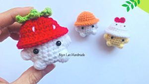 Little animal wearing a strawberry hat
